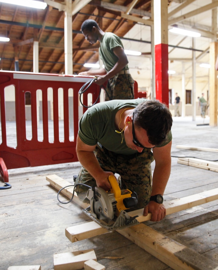 U.S. Marine Sgt. Charles R. Ross, squad leader with Headquarters and Service Company, 6th Engineer Support Battalion, 4th Marine Logistics Group, cuts a wooden plank with a circular saw at a construction site during exercise Red Dagger at Fort Indiantown Gap, Pa., May 23, 2018. Exercise Red Dagger is a bilateral training exercise that gives Marines an opportunity to exchange tactics, techniques and procedures as well as build working relationships with their British counterparts. (U.S. Marine Corps photo by Sgt. Melanie Wolf/Released)