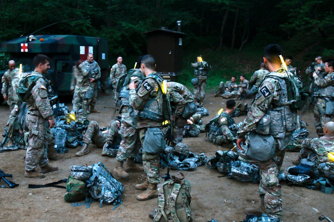 Soldiers prepare their equipment for the night land navigation event.