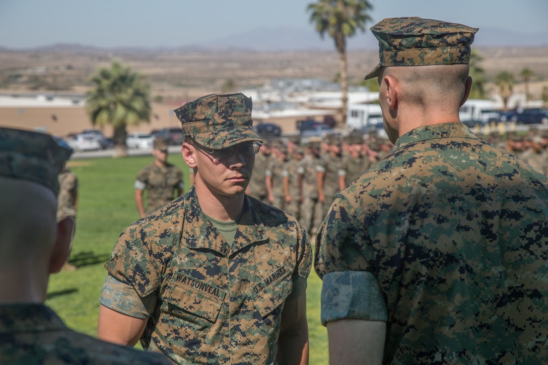 Lance Cpl. Tucker Watson-Veal, scout, 3rd Light Armored Reconnaissance Battalion, stands before Lt. Col. John S. Kinitz, commanding officer, 3rd LAR, and Sgt. Maj. Luis M. Ortega, sergeant major, 3rd LAR, during a ceremony at Lance Cpl. Torrey L. Gray Field aboard the Marine Corps Air Ground Combat Center, Twentynine Palms, Calif., May 24, 2018. Watson-Veal was awarded the Navy and Marine Corps Medal after rescuing a drowning person from rapid currents while on leave in 2016. (U.S. Marine Corps photo by Lance Cpl. Preston L. Morris)