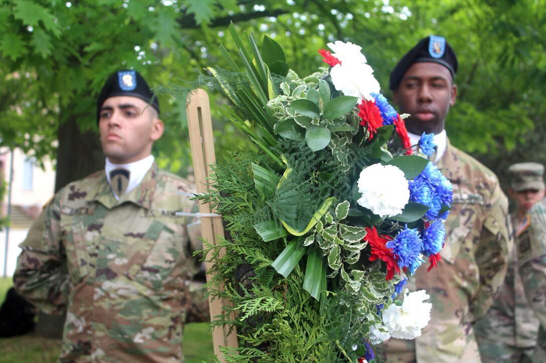 Two U.S. Army Europe soldiers participate in a Memorial Day ceremony.