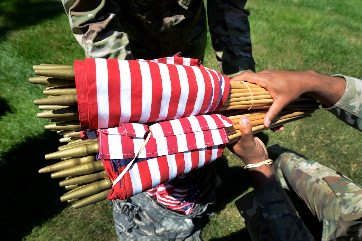 A soldier distributes flags.