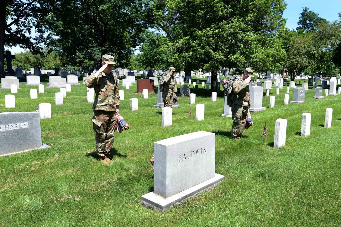 Soldiers render a salute to honor the fallen.