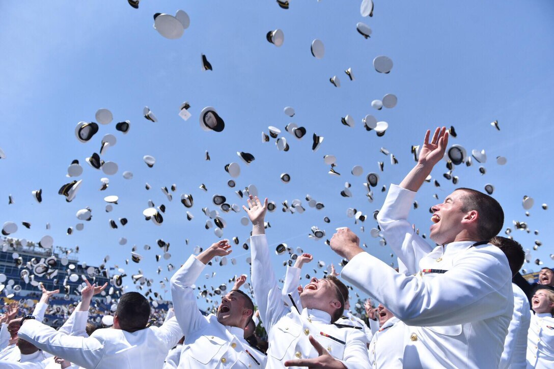 U.S. Naval Academy midshipmen from the Class of 2018 toss their hats in the air during the graduation and commissioning ceremony at Navy/Marine Corps Memorial Stadium in Annapolis, Md.