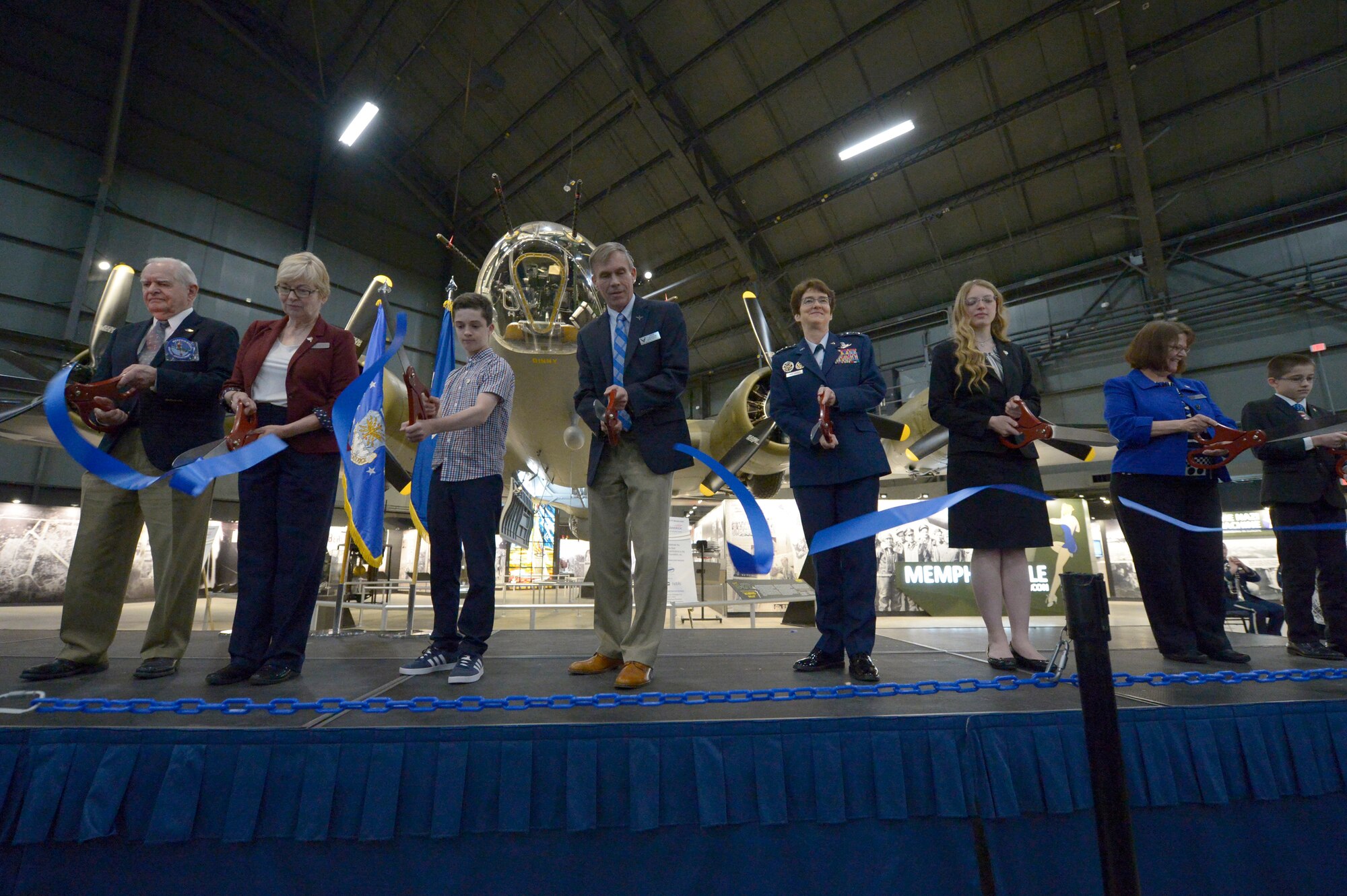 Special guests including National Museum of the U.S. Air Force Director retired Lt. Gen. John L. Hudson and Air Force Director of Staff Lt. Gen. Jacqueline D. Van Ovost cut the ceremonial ribbon for the public opening of the Memphis Belle at the National Museum of the U.S. Air Force, Ohio, May 17, 2018. The Memphis Belle crew completed their 25th mission in Europe exactly 75 years before the ribbon cutting ceremony. (U.S. Air Force photo by Staff Sgt. Megan Friedl)