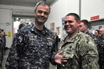 Captain Howard Markle, Puget Sound Naval Shipyard & Intermediate Maintenance Facility commander, presented the Navy and Marine Corps Medal to Navy Diver Chief Petty Officer Steven McConnell during an all hands call April 27, 2018, at the PSNS & IMF Everett Detachment’s headquarters at Naval Station Everett, Washington.