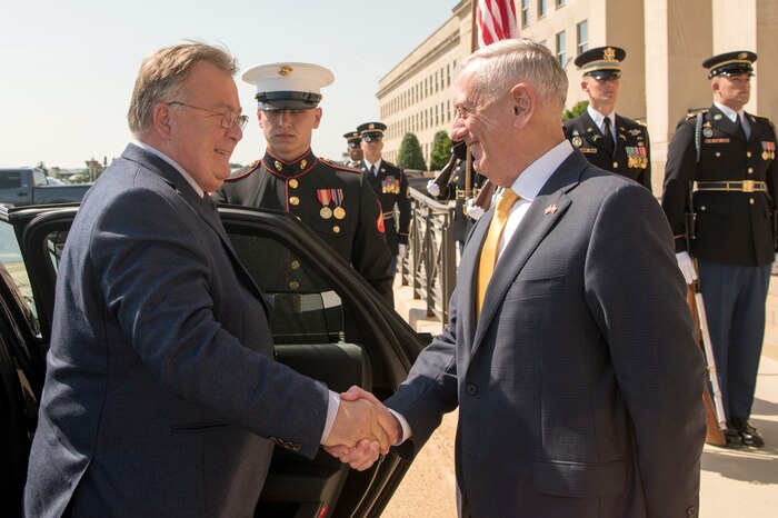Defense Secretary James N. Mattis shakes hands with a person.
