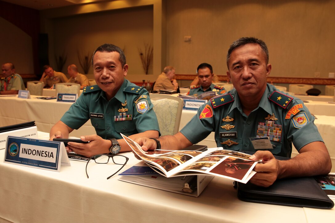Indonesian Marine Corps Brig. Gen. Nur Alamsyah, left, 2nd Marine Force Commander, Indonesian Marine Corps and Indonesian Navy First Adm. Rachmad Jayadi, commander, Sea Battle Task Force, Eastern Fleet Command, look over the Pacific Amphibious Leaders Symposium (PALS) photo book during PALS in Honolulu, Hawaii, on May 24, 2018. PALS brings together senior leaders of allied and partner militaries with significant interest in the security and stability of the Indo-Pacific region to discuss key aspects of maritime/amphibious operations, capability development, crisis response and interoperability. (U.S. Marine Corps photo by Cpl. Maximiliano Rosas)