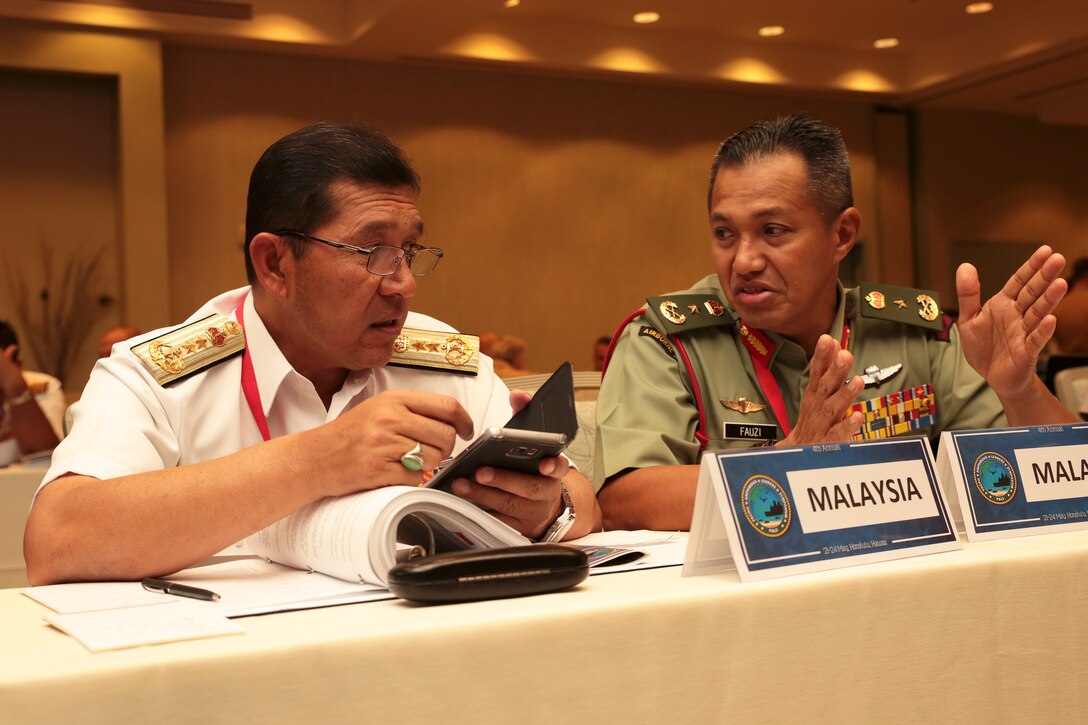 Malaysian Navy Rear Adm. Khairul Anuar Yahya, left, assistant chief of staff for operations and exercise, Naval Headquarters and and Brig. Gen. Tengku Muhammad Fauzi Tengku Ibrahim, Commander 10th Brigade, speak during the Pacific Amphibious Leaders Symposium (PALS) in Honolulu, Hawaii, May 21-24, 2018. PALS brings together senior leaders of allied and partner militaries with significant interest in the security and stability of the Indo-Pacific region to discuss key aspects of maritime/amphibious operations, capability development, crisis response and interoperability. (U.S. Marine Corps photo by Cpl. Maximiliano Rosas)