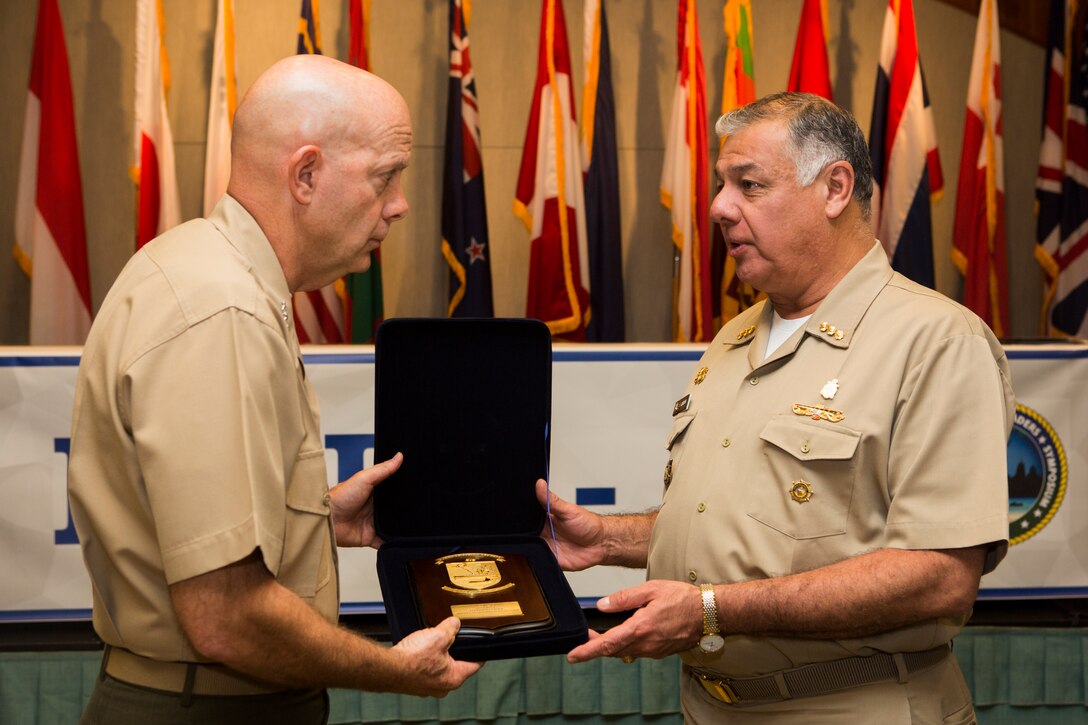 U.S. Marine Lt. Gen. David H. Berger, commander, U.S. Marine Corps Forces, Pacific, receives a gift from Peruvian Vice Admiral Fernando Cerdan, commander, Pacific Operations General Command, during the Pacific Amphibious Leaders Symposium (PALS) 2018 held in Honolulu, Hawaii, May 21-24, 2018. PALS brings together senior leaders of allied and partner militaries with significant interest in the security and stability of the Indo-Pacific region to discuss key aspects of maritime/amphibious operations, capability development, crisis response and interoperability. (U.S. Marine Corps photo by Cpl. Patrick Mahoney)