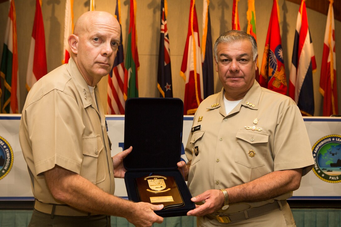 Peruvian Vice Admiral Fernando Cerdan, commander, Pacific Operations General Command, gives a gift to U.S. Marine Corps Lt. Gen. David H. Berger, commander, U.S. Marine Corps Forces, Pacific, during the Pacific Amphibious Leaders Symposium (PALS) 2018 in Honolulu, Hawaii, May 24, 2018. PALS brings together senior leaders of allied and partner militaries with significant interest in the security and stability of the Indo-Pacific region to discuss key aspects of maritime/amphibious operations, capability development, crisis response and interoperability. (U.S. Marine Corps photo by Cpl. Patrick Mahoney)