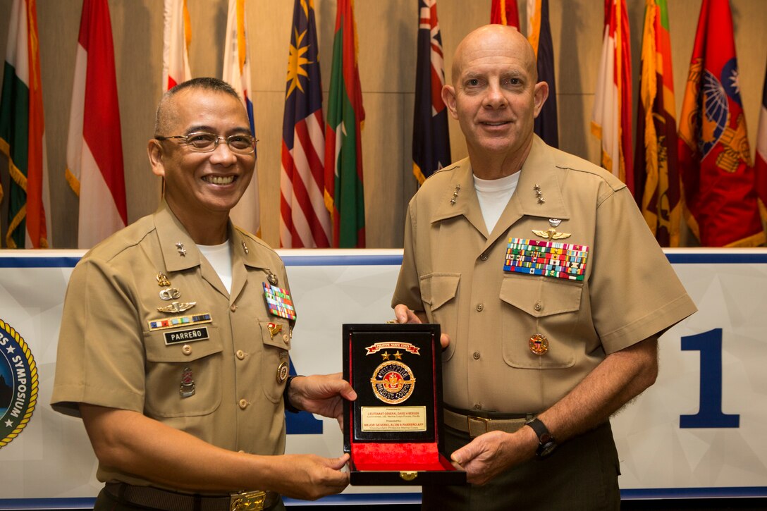 Philippine Marine Corps Maj. Gen. Alvin A. Parreno, commandant, Philippine Marine Corps, gives a gift to U.S. Marine Corps Lt. Gen. David H. Berger, commander, U.S. Marine Corps Forces, Pacific, during the Pacific Amphibious Leaders Symposium (PALS) 2018 in Honolulu, Hawaii, May 24, 2018. PALS brings together senior leaders of allied and partner militaries with significant interest in the security and stability of the Indo-Pacific region to discuss key aspects of maritime/amphibious operations, capability development, crisis response and interoperability. (U.S. Marine Corps photo by Cpl. Patrick Mahoney)