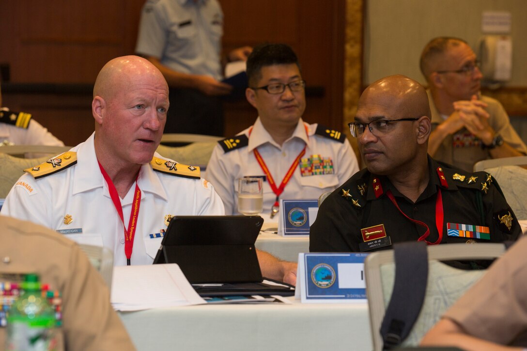 Royal Canadian Navy Commodore Dan MacKeigan, left, strategic advisor commander, Canadian Naval Staff Ottawa, speaks with Indian Brigadier Arun Chaloli Gopinath, commander, Infantry Brigade India, during the Pacific Amphibious Leaders Symposium (PALS) 2018 in Honolulu, Hawaii, May 24, 2018. PALS brings together senior leaders of allied and partner militaries with significant interest in the security and stability of the Indo-Pacific region to discuss key aspects of maritime/amphibious operations, capability development, crisis response and interoperability. (U.S. Marine Corps photo by Cpl. Patrick Mahoney)