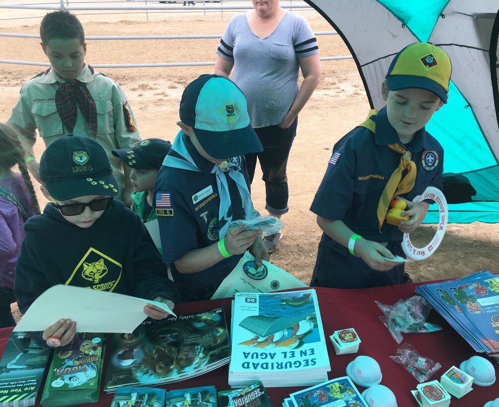 Boy Scouts check out "Bobber the Safety Dog" materials and other U.S. Army Corps of Engineers information during a May 12 community tree-planting event in Norco, California.
