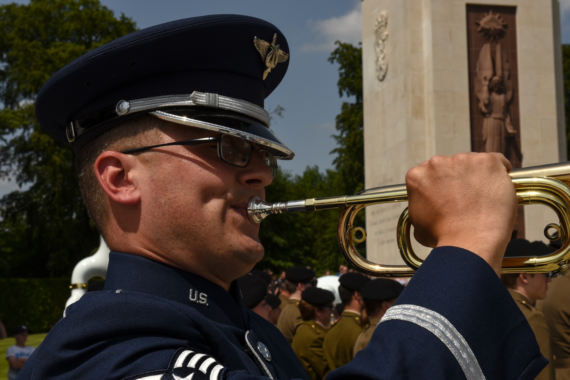 A U.S. Air Force service member preforms Taps after an observed moment of silence during the Memorial Day Ceremony at Luxembourg American Military Cemetery in Hamm, Luxembourg, May 26, 2018. Taps is a bugle call typically played at dusk, during flag ceremonies and military funerals to honor fallen members of the U.S. Armed Forces. (U.S. Air Force photo by Senior Airman Dawn M. Weber)