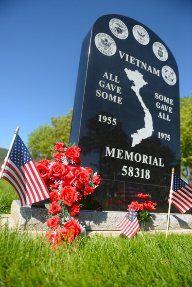 A Vietnam War memorial obelisk stands adorned with flags and flowers for Memorial Day weekend at the Black Hills National Cemetery near Sturgis, S.D., May 26, 2018. The Black Hills National Cemetery sees more than 10,000 visitors during Memorial Day weekend. (U.S. Air Force photo by Airman 1st Class Nicolas Z. Erwin)