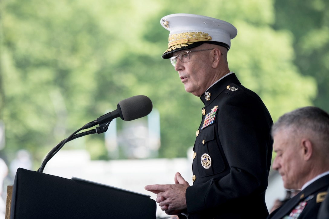 The chairman of the Joint Chiefs of Staff speaks into a microphone.