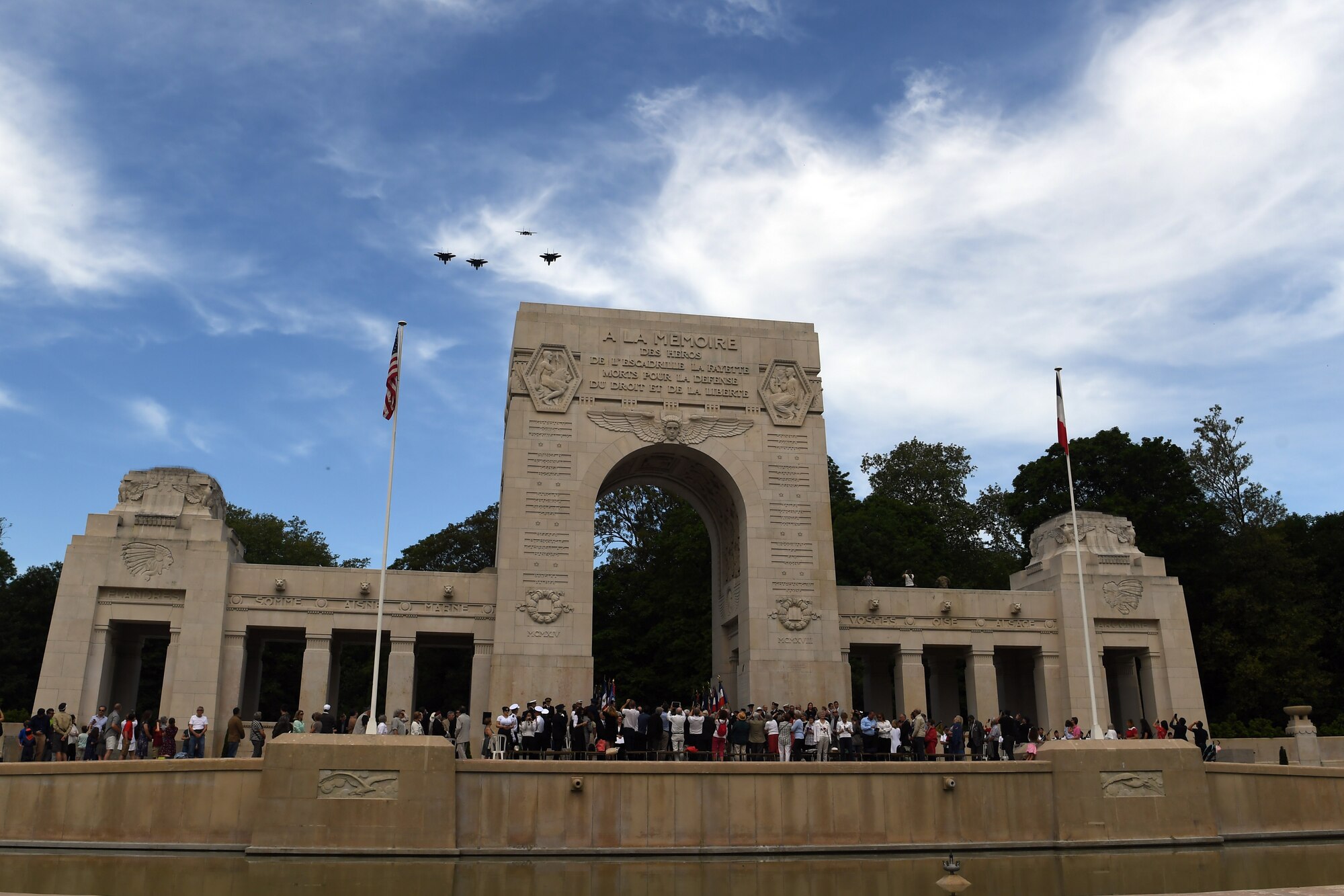 Four F-15 fighters fly in formation over the Lafayette Escadrille Memorial.