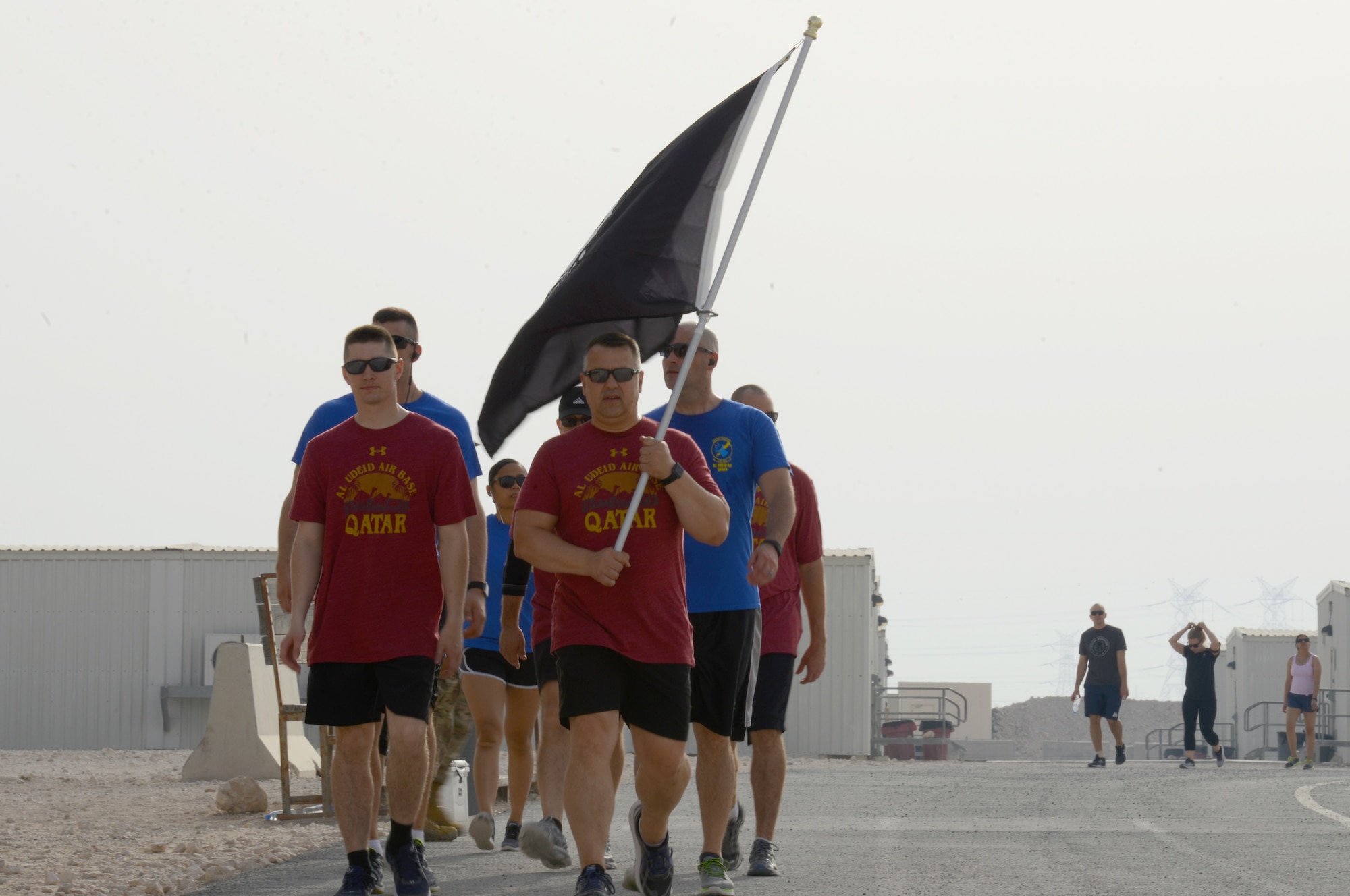 Members from 379th Air Expeditionary Wing carry the POW/MIA flag during a 12-hour rememberance run and walk event,  Al Udeid Air Base, Qatar, May 24, 2018. The event was held tandem with a Memorial Day ceremony which recognized and honored all those who gave the ultimate sacrifice for our freedom. (U.S. Air Force photo by 1st Lt. Katie Spencer)