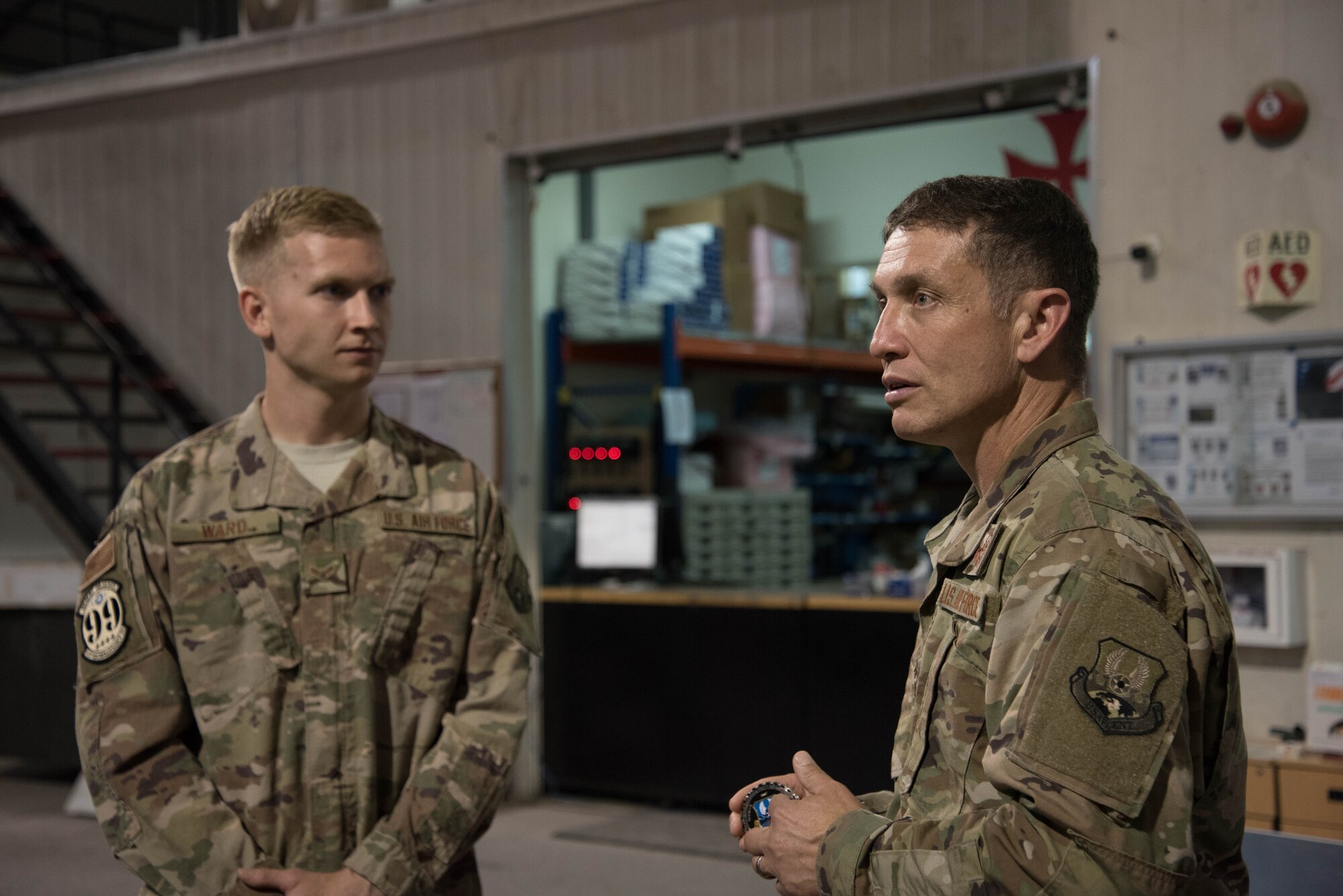 U.S. Air Force Chief Master Sgt. Joseph Montgomery, U.S. Air Forces Central Command Chief, speaks to 380th Expeditionary Maintenance Squadron members during his visit to Al Dhafra Air Base, May 25. Montgomery coined outstanding performers and briefed Airmen on the importance of their deployed mission. (U.S. Air Force photo by Staff Sgt. Erica Rodriguez)