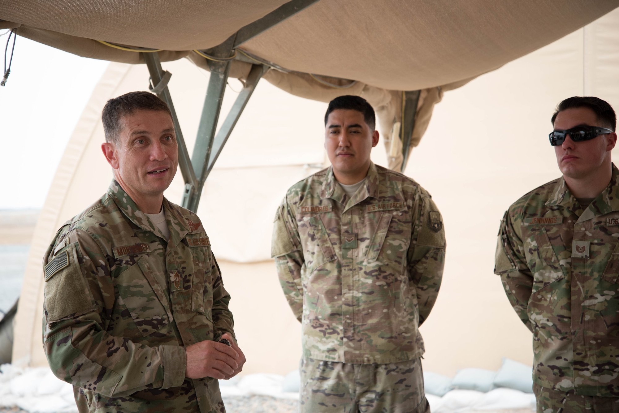 U.S. Air Force Chief Master Sgt. Joseph Montgomery, U.S. Air Forces Central Command Chief, speaks to 380th Expeditionary Maintenance Squadron members during his visit to Al Dhafra Air Base, May 25. Montgomery coined outstanding performers and briefed Airmen on the importance of their deployed mission. (U.S. Air Force photo by Staff Sgt. Erica Rodriguez)
