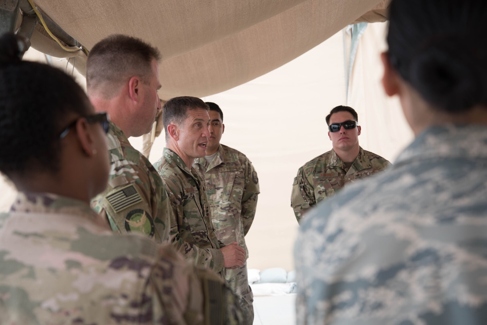 U.S. Air Force Chief Master Sgt. Joseph Montgomery, U.S. Air Forces Central Command Chief, speaks to 380th Expeditionary Maintenance Squadron members during his visit to Al Dhafra Air Base, May 25. Montgomery coined outstanding performers and briefed Airmen on the importance of their deployed mission. (U.S. Air Force photo by Staff Sgt. Erica Rodriguez)