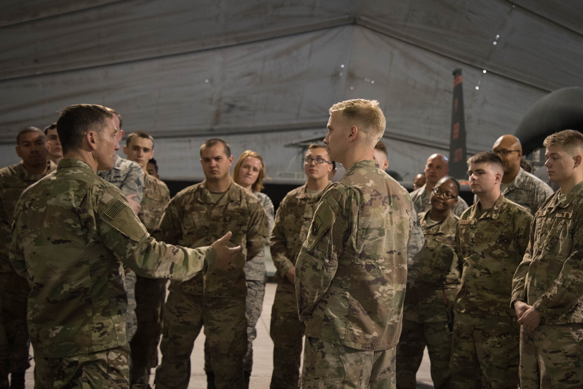 U.S. Air Force Chief Master Sgt. Joseph Montgomery, U.S. Air Forces Central Command Chief, speaks to 380th Expeditionary Maintenance Squadron members during his visit to Al Dhafra Air Base, May 25. Montgomery coined outstanding performers and briefed Airmen on the importance of their deployed mission. (U.S. Air Force photo by Staff Sgt. Erica Rodriguez)