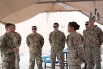 U.S. Air Force Chief Master Sgt. Joseph Montgomery, U.S. Air Forces Central Command Chief, speaks to 380th Expeditionary Maintenance Squadron members during his visit to Al Dhafra Air Base, May 25. Montgomery coined outstanding performers and briefed Airmen on the importance of their deployed mission. (U.S. Air Force photo by Staff Sgt. Erica Rodriguez)
