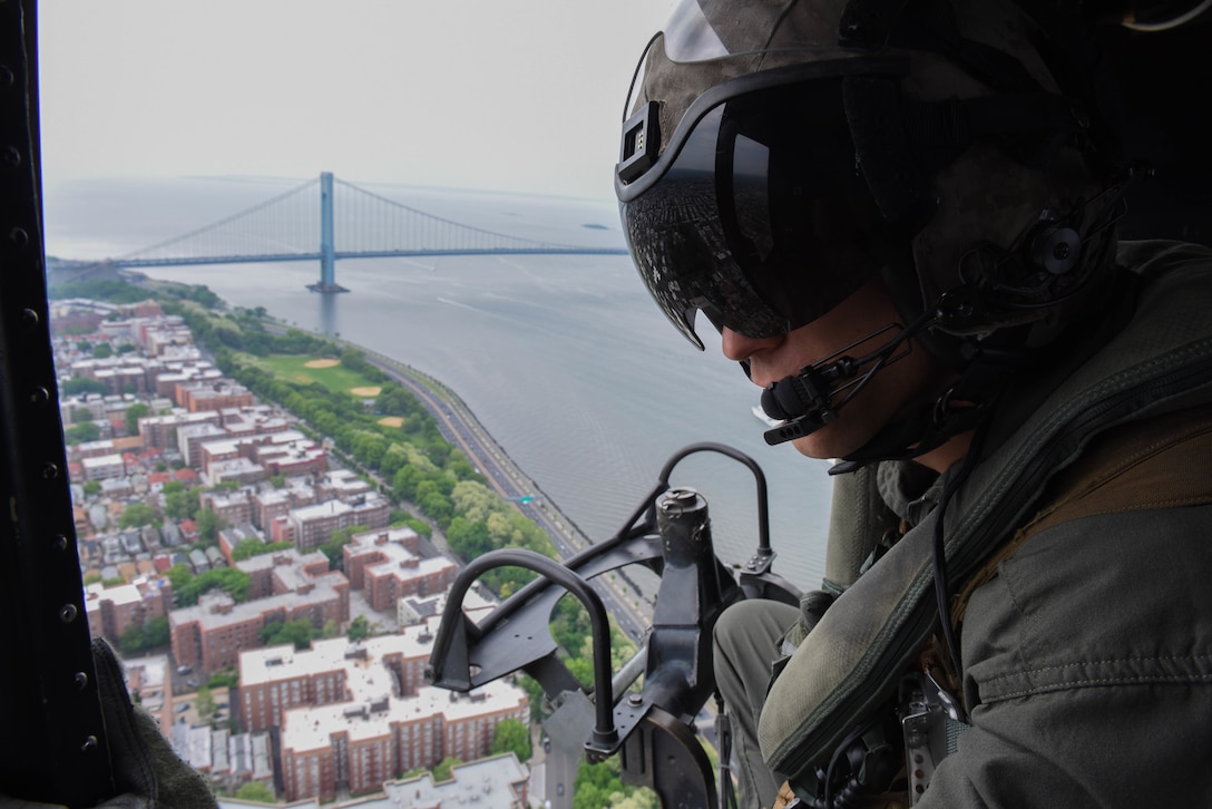 Staff Sgt. Raymond Brown, with Special Purpose Marine Air-Ground Task Force Fleet Week New York, watches the Manhattan Bridge and New York pass below on a flight to Marine Day at Prospect Park in Brooklyn, New York, May 26. Now in its 30th year, Fleet Week is the city’s time-honored celebration of the sea services. It is an unparalleled opportunity for the citizens of New York and the surrounding tri-state area to meet Marines, Sailors, and Coast Guardsmen, as well as witness firsthand the latest capabilities of today’s maritime services.