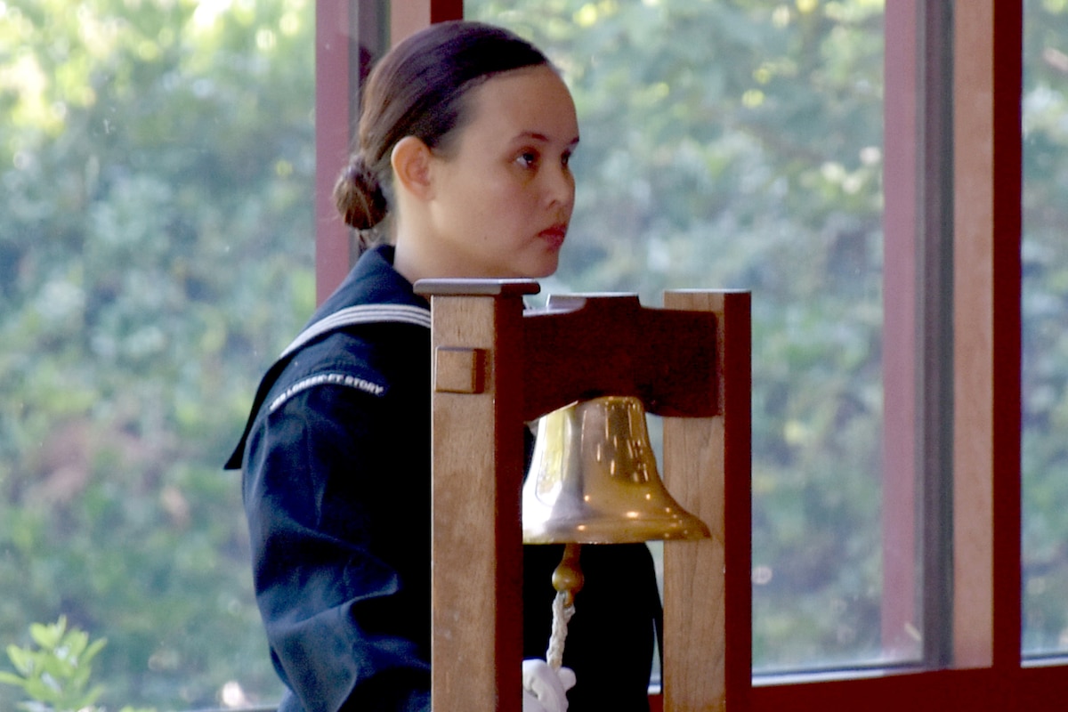 A sailor rings a bell.