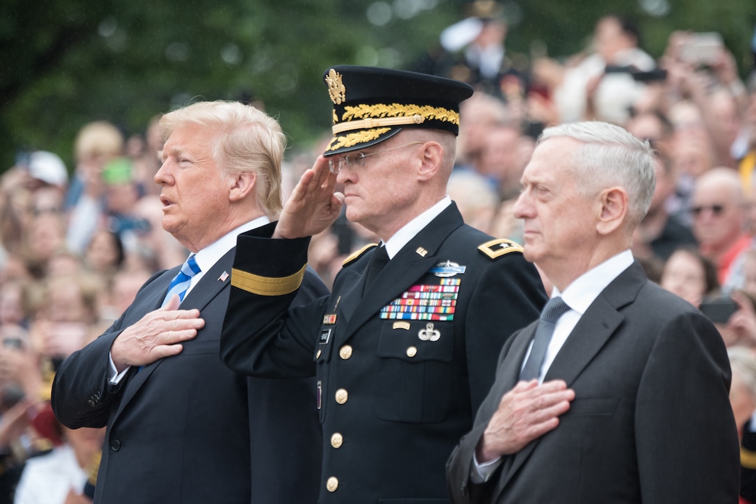 The president, an Army officer and the defense secretary render honors.