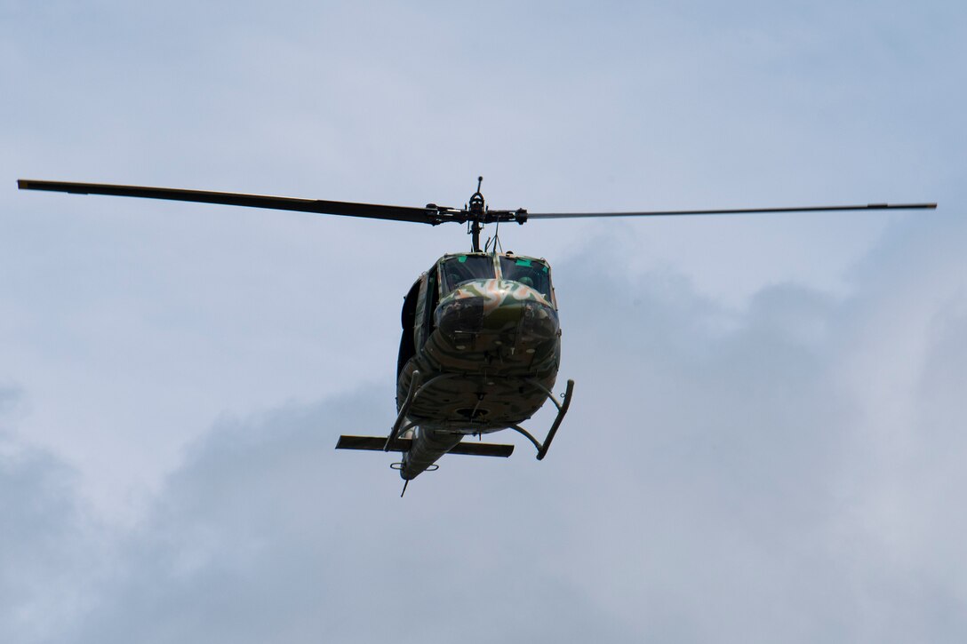 A UH-1 "Huey" helicopter, flies over a Memorial Day ceremony, May 28, 2018 at the Cape Canaveral National Cemetery, Fla. The UH-1 helicopter was used extensively in the Vietnam War. (U.S. Air Force photo by Airman 1st Class Dalton Williams)