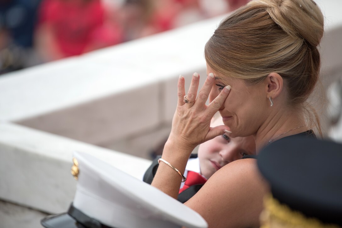 A woman cries while holding a child.
