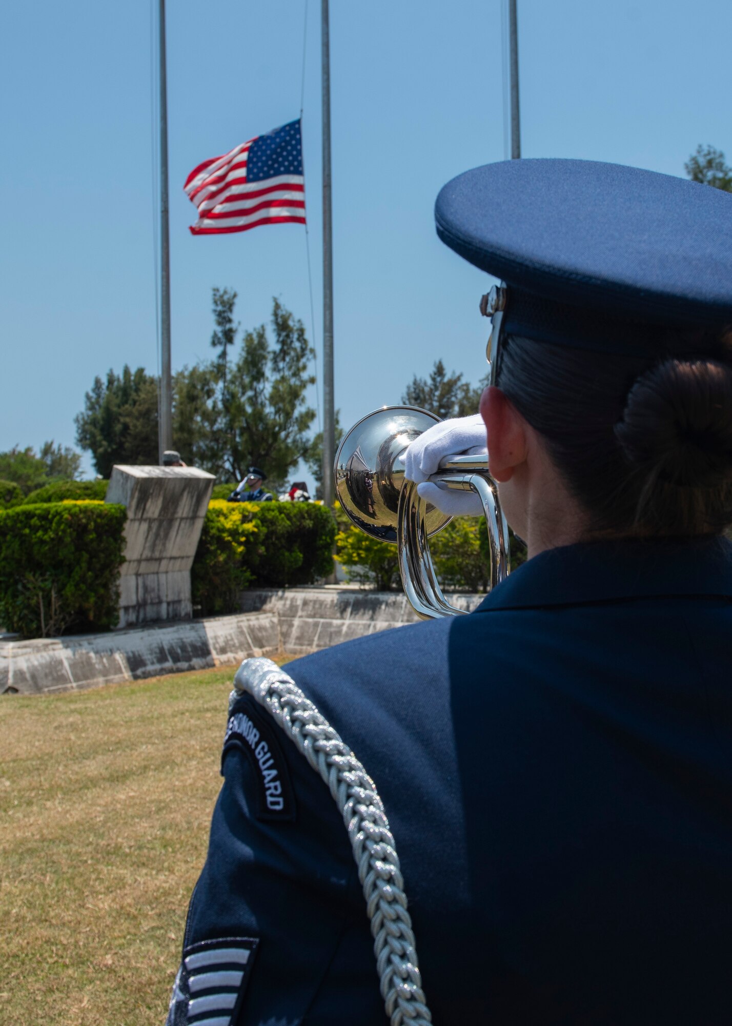 A Kadena Air Base honor guardsman holds a bugle in place as the bugle plays Taps during a Memorial Day ceremony May 25, 2018, at Kadena Air Base, Japan. Members of Team Kadena gathered to remember and honor U.S. service members who paid the ultimate sacrifice for their country. (U.S. Air Force photo by Staff Sgt. Micaiah Anthony)