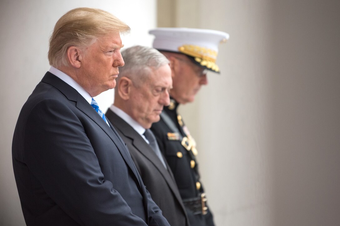 The president, defense secretary and chairman of the Joint Chiefs of Staff stand in a row.