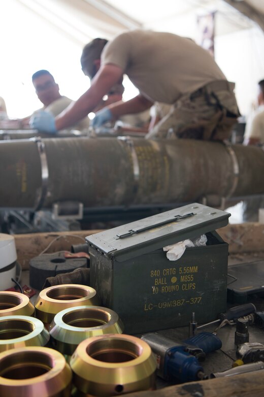 Airmen with the 332nd Expeditionary Maintenance Squadron Munitions Flight builds bombs for the F-15E at an undisclosed location in Southwest Asia May 19, 2018.