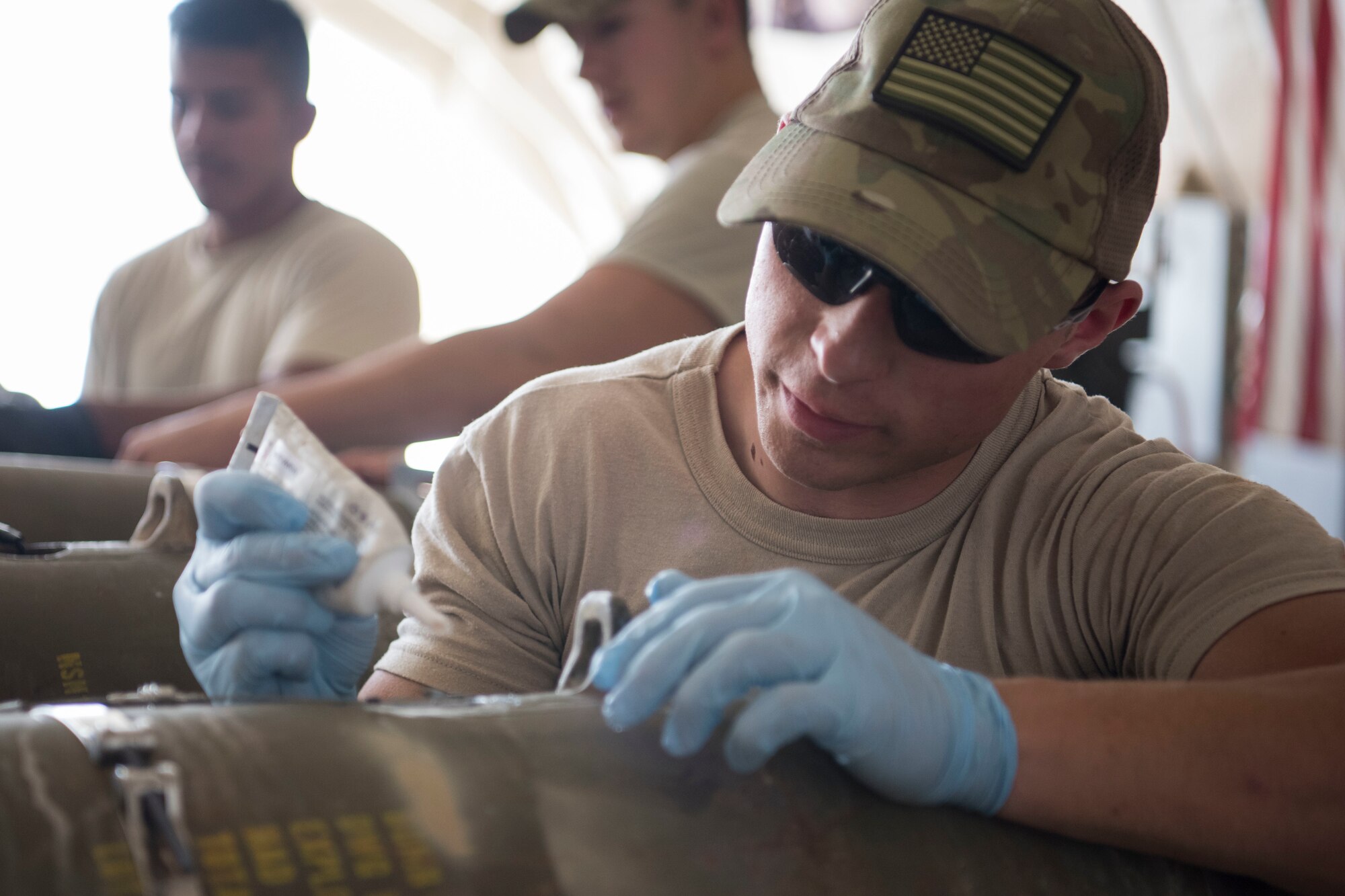 Airmen with the 332nd Expeditionary Maintenance Squadron Munitions Flight builds bombs for the F-15E at an undisclosed location in Southwest Asia May 19, 2018.