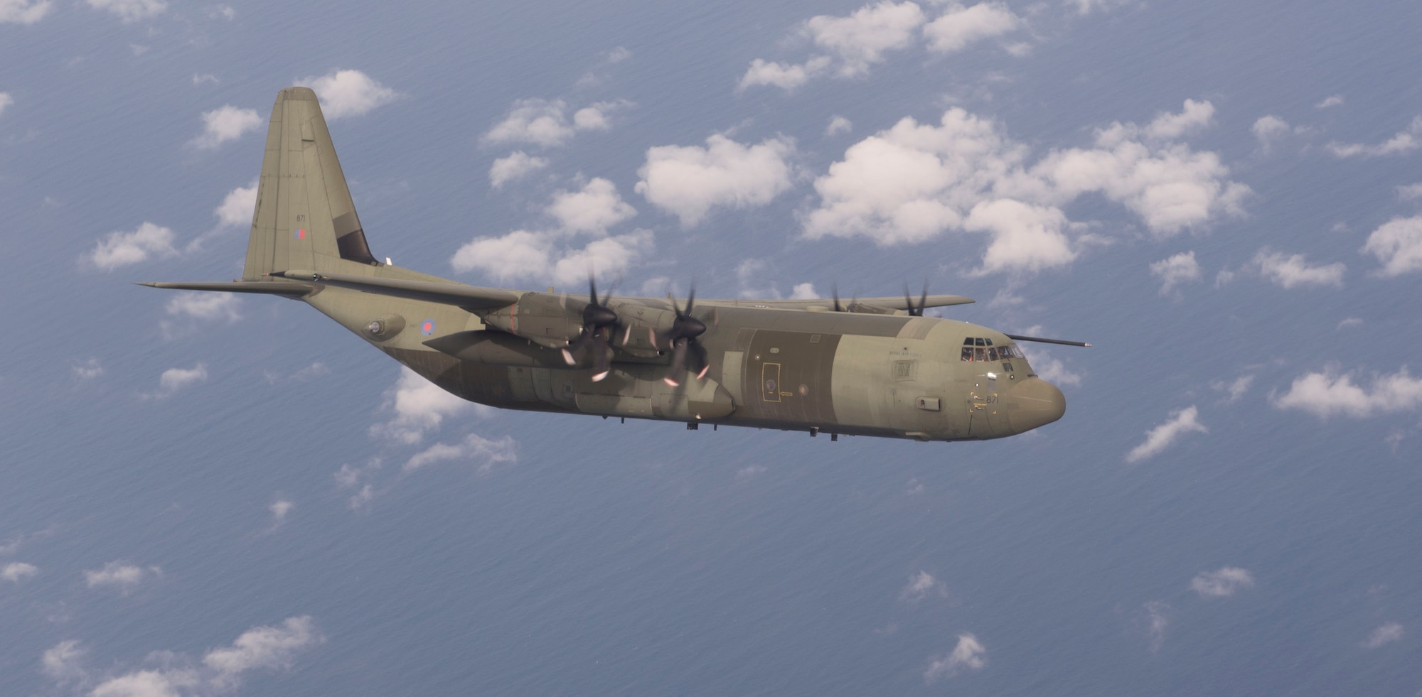 A Royal Air Force C-130 Hercules flies, over England, during the RAF Mildehall hosted European Tanker Symposium, May 17, 2018. The varying nations’ participating included air force pilots from the UK, Netherlands, and France, who were were able to fly in a mixed formation. (U.S. Air Force photo by Airman 1st Class Alexandria Lee)