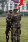 Soldiers passing unit flag