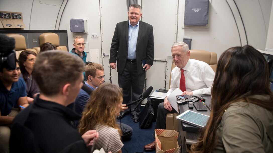 Defense Secretary James N. Mattis speaks with reporters on a plane.