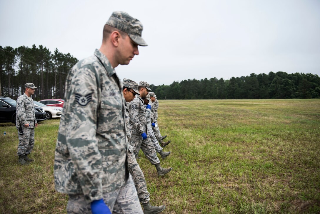 U.S. Airmen practice walking in a search and recovery line during an exercise at Shaw Air Force Base, S.C., May 23, 2018.