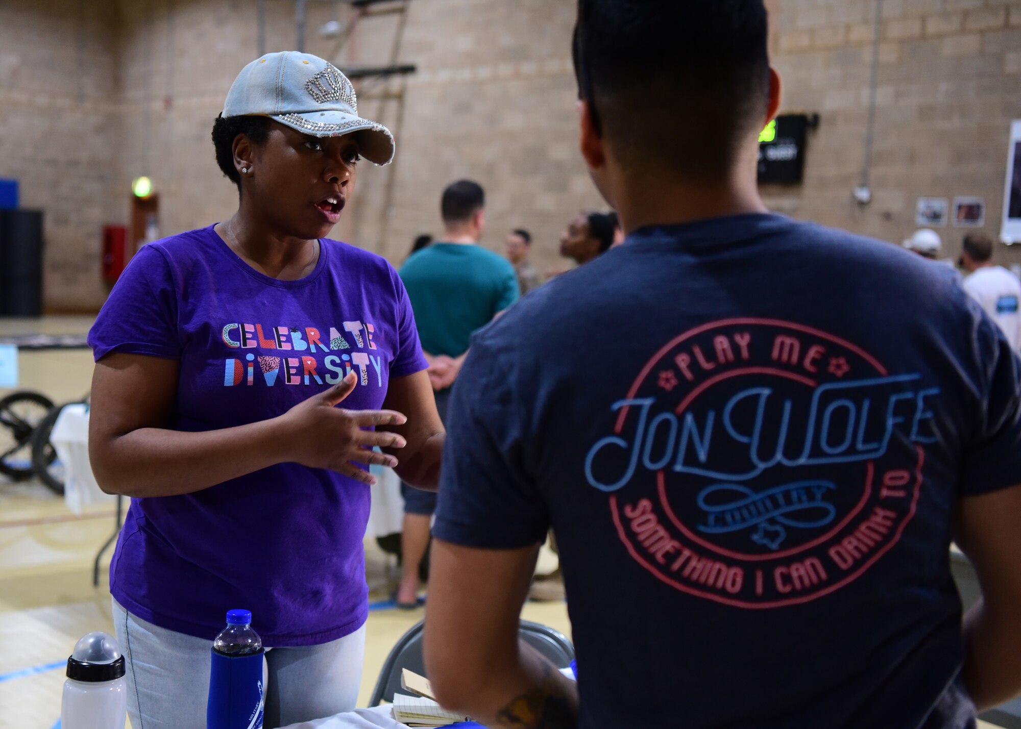 Tech. Sgt. Ebone Walker, 386th Air Expeditionary Wing Equal Opportunity regional director, speaks to an event-goer during the Holistic Health Fair May 26, 2018, at an undisclosed location in Southwest Asia. The fair provided attendees an opportunity to learn more about the physical, social, spiritual and mental health. (U.S. Air Force photo by Staff Sgt. Christopher Stoltz)