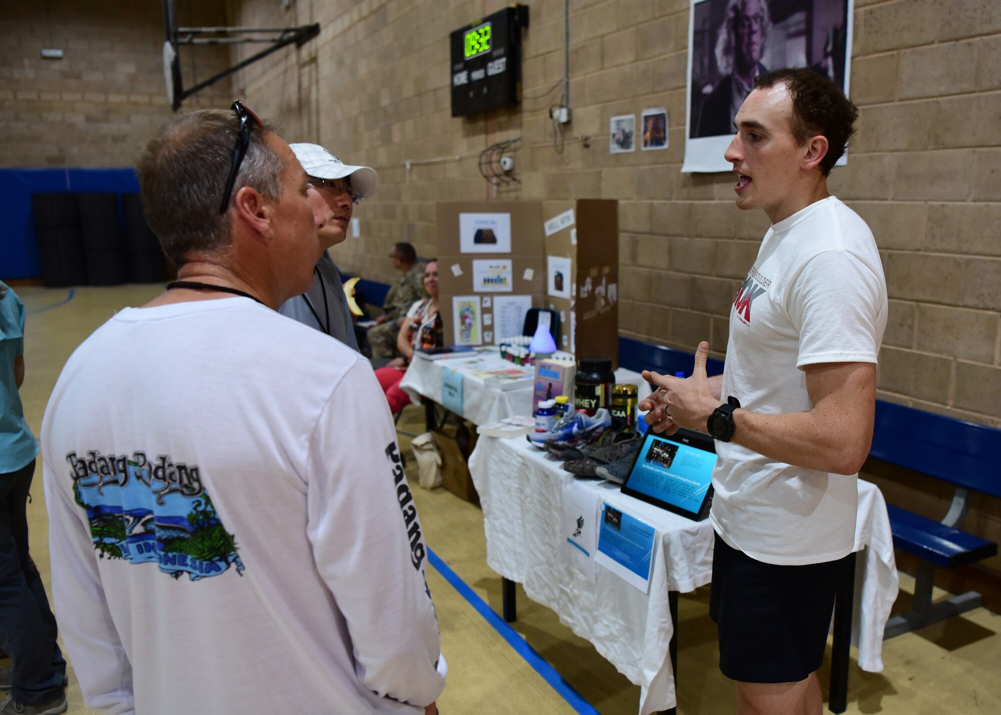 Senior Airman Crayton Noe, 386th Expeditionary Logistics Readiness Squadron fuels technician, speaks about his running club to event-goers during the Holistic Health Fair May 26, 2018, at an undisclosed location in Southwest Asia. In addition to Noe’s booth, event-goers were given gifts and information about holistic health from various booths across the wing. (U.S. Air Force photo by Staff Sgt. Christopher Stoltz)