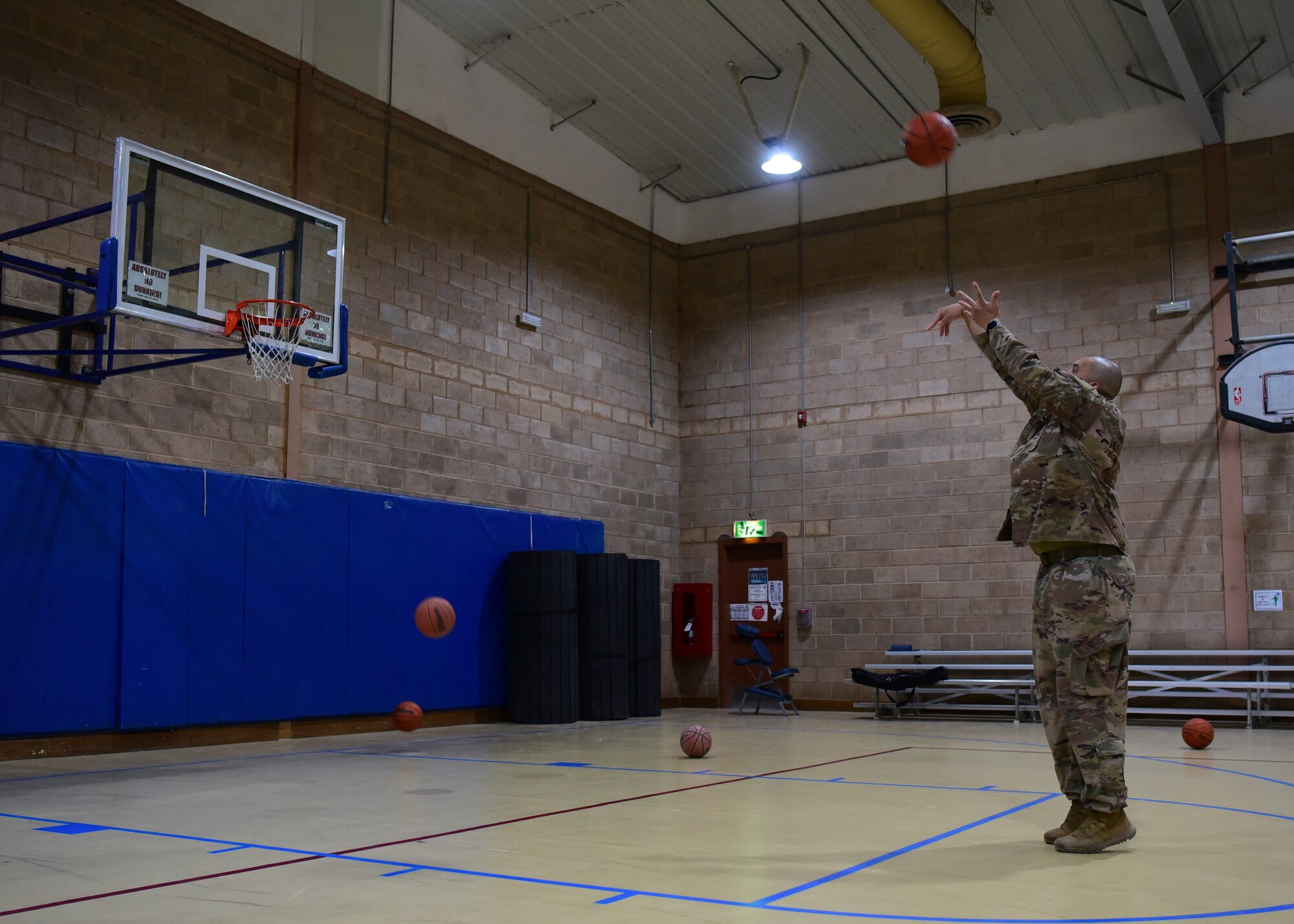 Staff Sgt. Gregory Johnson, 386th Expeditionary Medical Group dental services non-commissioned officer in charge, shoots free throws during the Holistic Health Fair May 26, 2018, at an undisclosed location in Southwest Asia. The fair, hosted by the 386th EMDG, provided guests an opportunity to learn more about the concepts of holistic health. (U.S. Air Force photo by Staff Sgt. Christopher Stoltz)