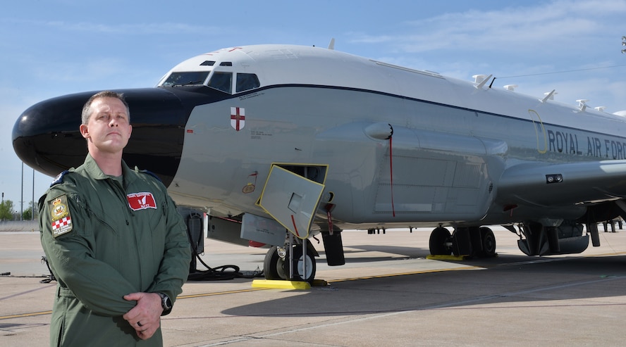 Royal Air Force Master Aircrew Keith Wing, 56 Squadron Rivet Joint specialist, poses in front of a RAF RC-135W Rivet Joint aircraft May 8, 2018, at Offutt Air Force Base, Nebraska.