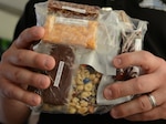 The prototype Close Combat Assault Ration on display at the Pentagon May 24, 2018, includes a tart cherry nut bar, cheddar cheese bar, mocha desert bar, vacuum-dried strawberries and trail mix of fruit and nuts, among other items that were vacuum-microwave dried