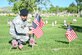 Airman 1st Class Jose Rosales-Nunez, 75th Security Forces, places a flag May 26,2018, at the Veterans Memorial Cemetery at Camp Williams, Utah. Several Airmen from Hill Air Force Base participated in the annual flag laying event over Memorial Day weekend. (U.S Air Force photo by Cynthia Griggs)