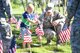 Senior Airman James Webb, 388th Maintenance Squadron, places a flag with Jaxton Gardner, son of Master Sergeant Phillip Gardner, 729th Air Control Squadron, May 26, 2018, at the Veterans Memorial Cemetery at Camp Williams, Utah. Several Airmen from Hill Air Force Base participated in the annual flag laying event over Memorial Day weekend. (U.S. Air Force photo by Cynthia Griggs)