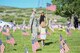 Tech. Sgt. Adrian Villa, 419th Fighter Wing, places a flag with her daughter, Presley Wigman, May 26, 2018, at the Veterans Memorial Cemetery at Camp Williams, Utah. Several Airmen from Hill Air Force Base participated in the annual flag laying event over Memorial Day weekend. (U.S. Air Force photo by Cynthia Griggs)