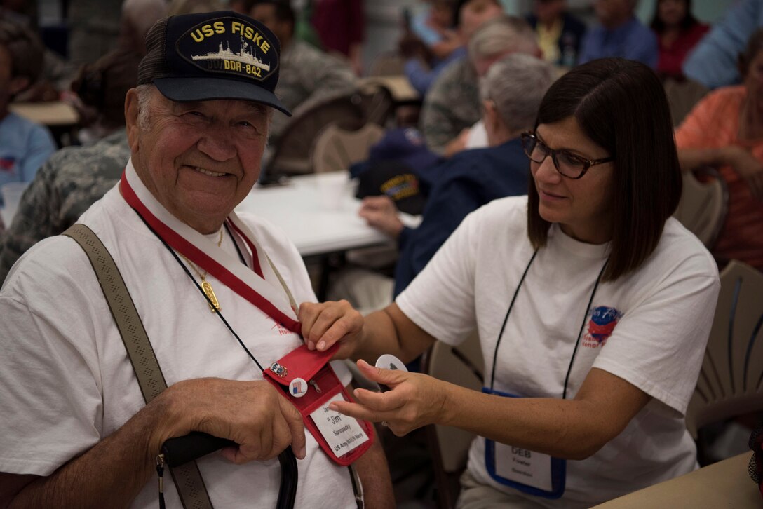 James "Jim" Konopacky, a former U.S. Army National Guardsman and U.S. Navy sailor, has his button pinned on by his guardian Deb Fowler, May 26, 2018 at the Wickham Park Senior Center in Melbourne, Fla. Konopacky served from 1947 until 1955. (U.S. Air Force photo by Airman 1st Class Zoe Thacker)