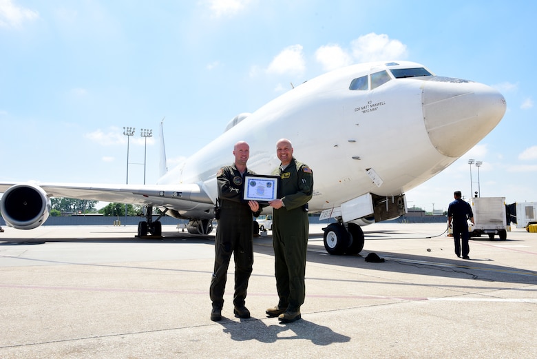 Capt. Paul Bouvier, left, an Airborne Launch Control System intelligence officer and strike planner at the 625th Strategic Operations Squadron, holds a certificate presented to him by Brig. Gen. Christopher Coffelt, right, the deputy director of Nuclear Operations at U.S. Strategic Command, in front of the U.S. Navy E-6B at Offutt Air Force Base, Nebraska, May 21, 2018. The certificate commemorated Bouvier’s 400th alert, a significant accomplishment for an officer in his field. (U.S. Air Force photo by Staff Sgt. Rachel Hammes)